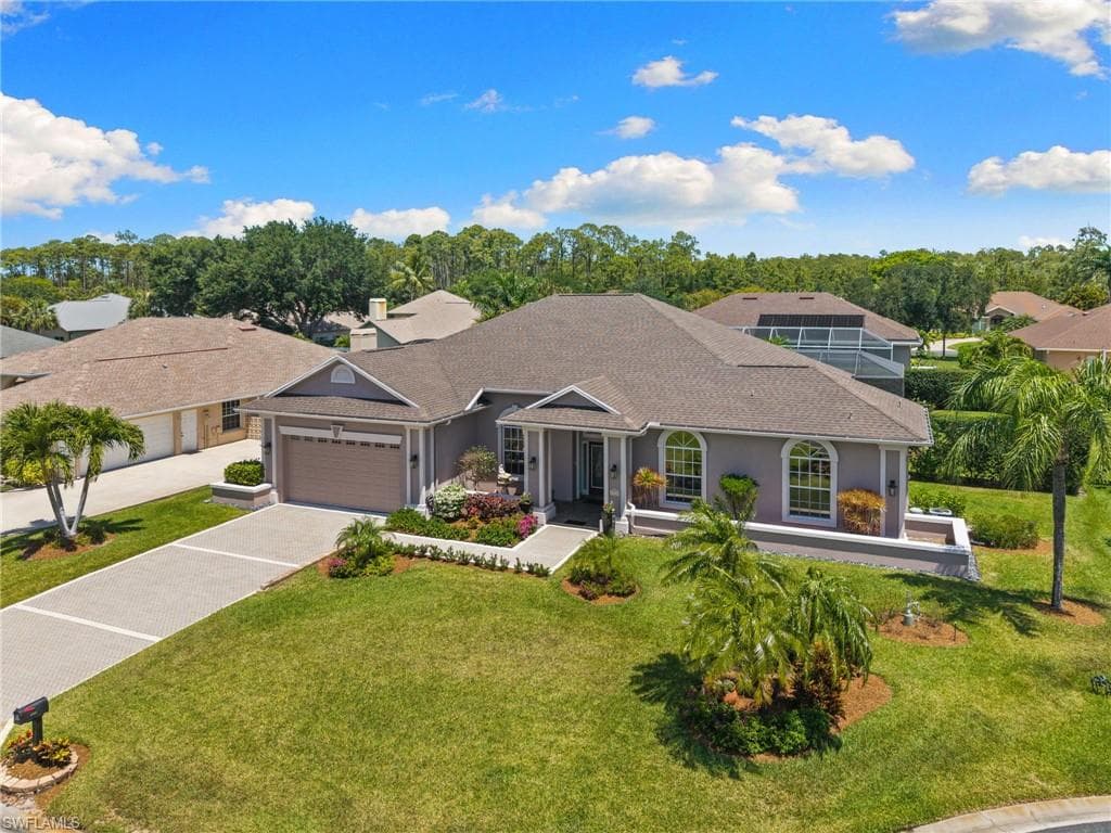 Contemporary single-story residence featuring a neutral stucco exterior, hip roof, and arched windows