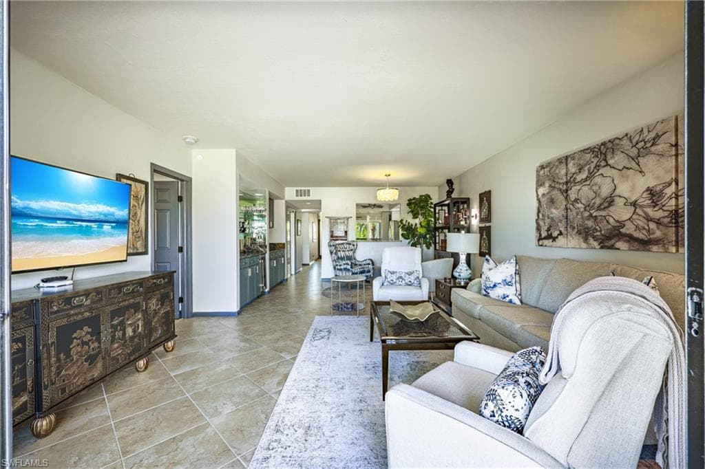 Spacious living area featuring tile flooring, neutral wall tones, and recessed lighting
