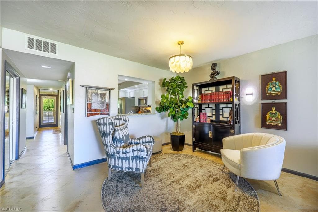 Entryway featuring light-toned tile flooring, recessed ceiling lighting, and a decorative pendant light fixture