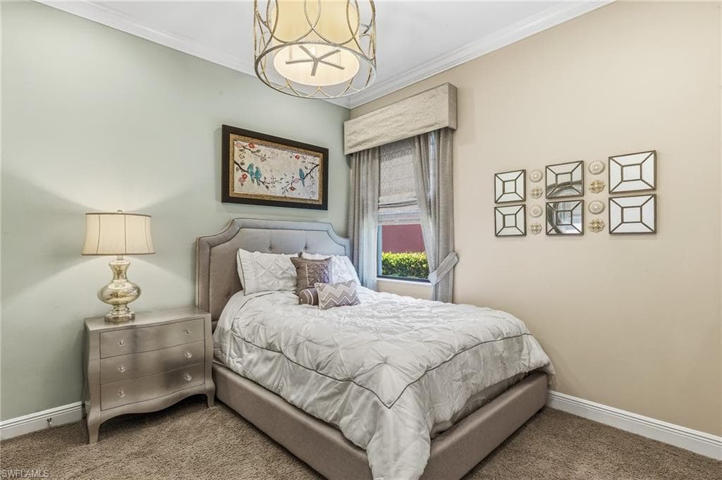 Neutral-toned room with plush carpeting and crown molding