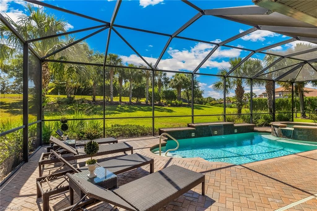 Screened-in outdoor living space with a brick paver patio