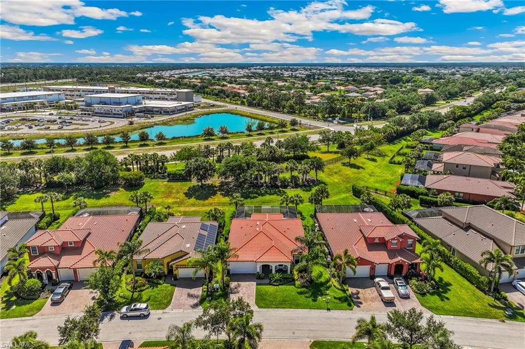 Aerial perspective showcasing a residential community with red tile roofs and extensive green spaces