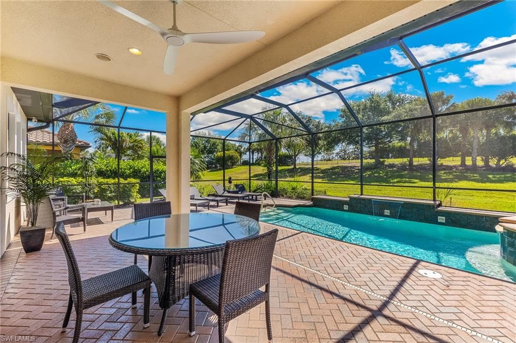Screened lanai featuring a paver patio and a built-in ceiling fan