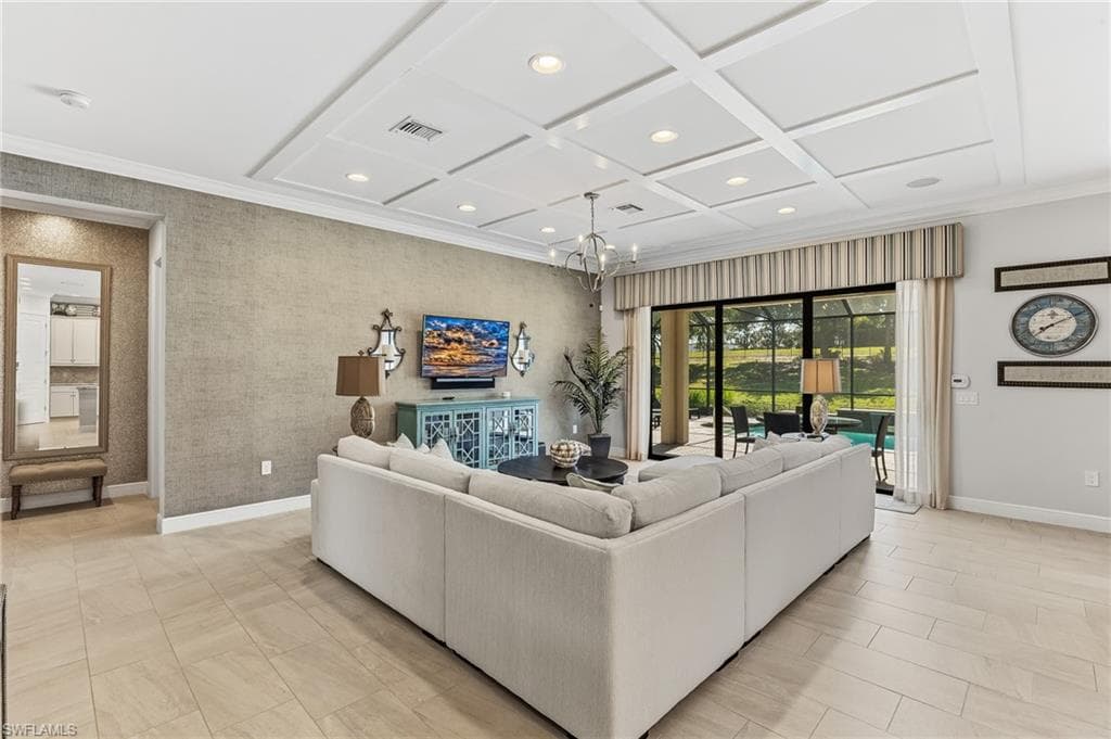 Living space featuring coffered ceilings with recessed lighting, large format tile flooring, and textured wall finishes