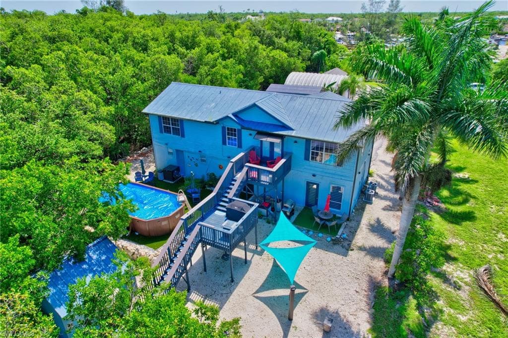 Two-story residence with a blue exterior and metal roof