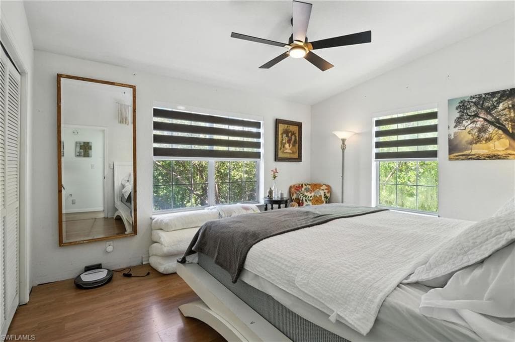 Vaulted ceilings enhance this room featuring wood-finish flooring
