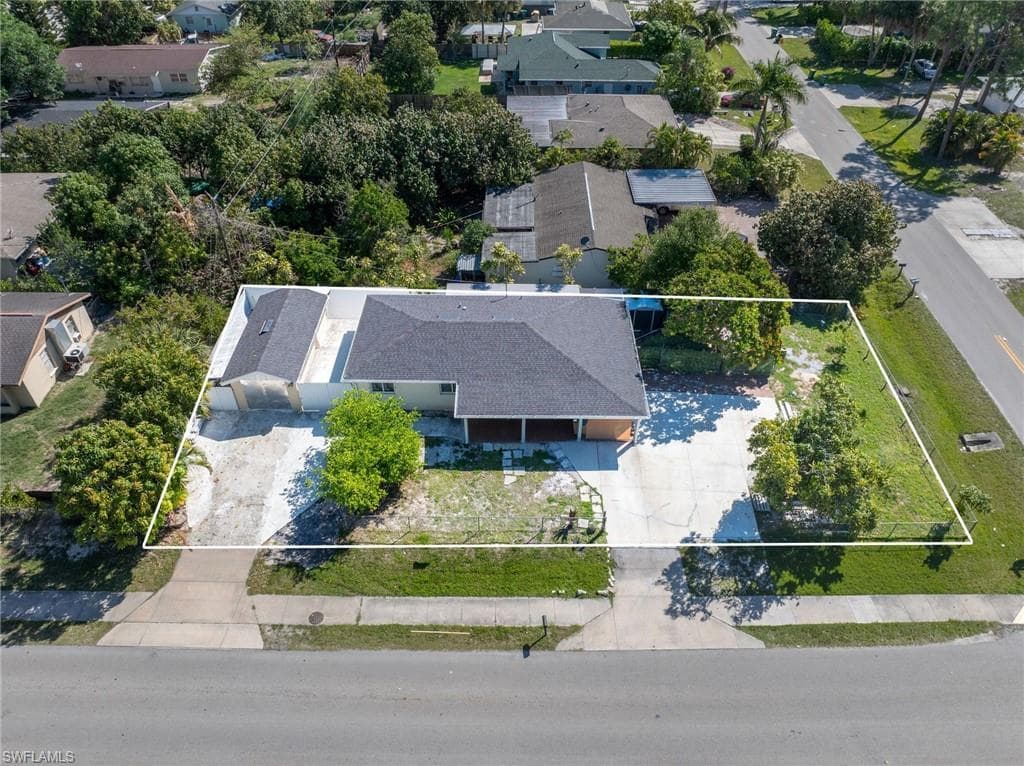 Single-story residence featuring a dark shingle roof and an attached garage