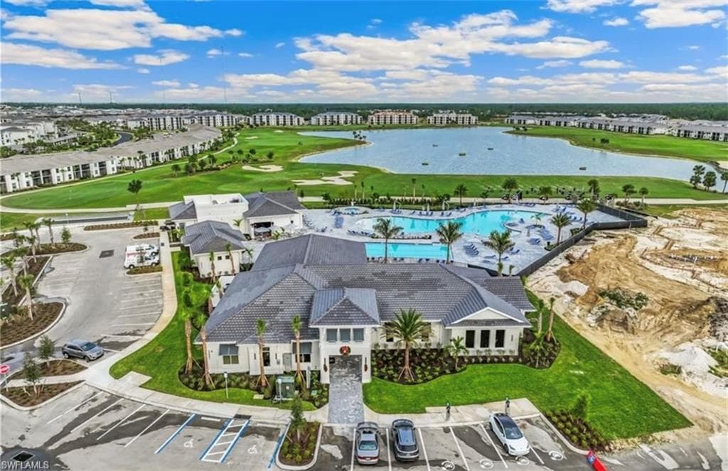 Community clubhouse with a large swimming pool and ample lounge areas