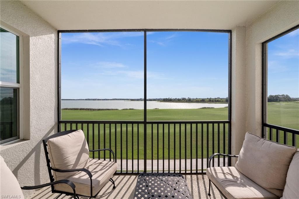Screened balcony with expansive lake and green space views