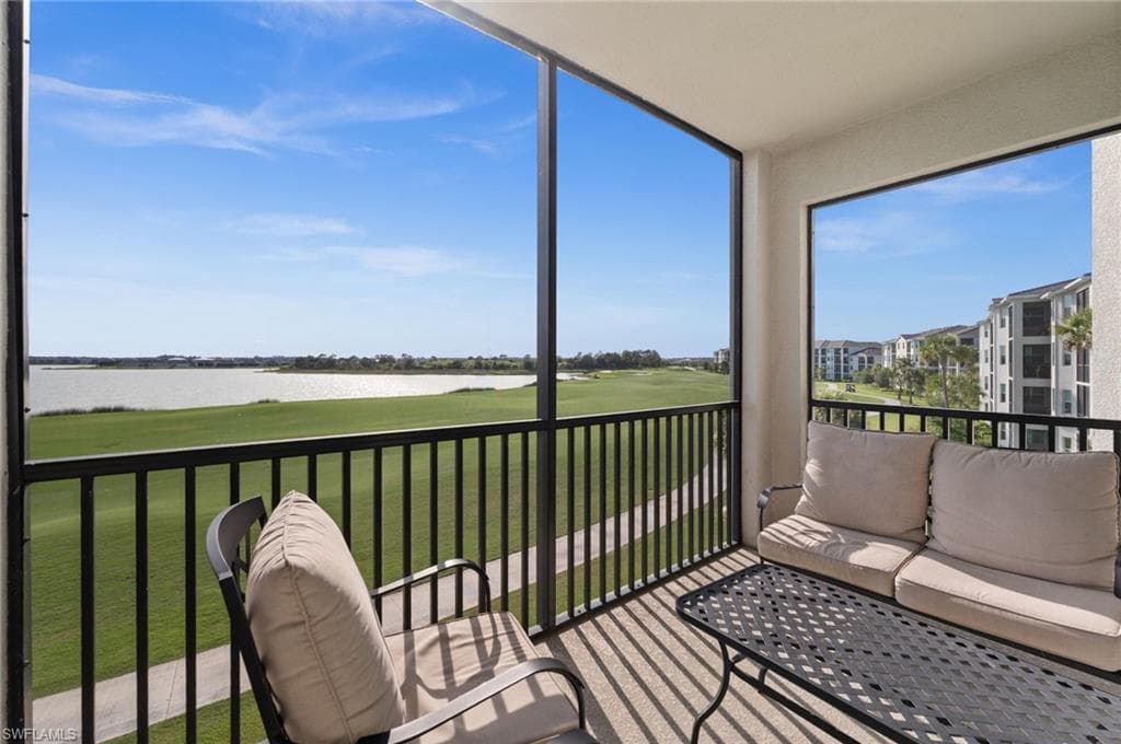 Screened balcony featuring expansive water and golf course scenery