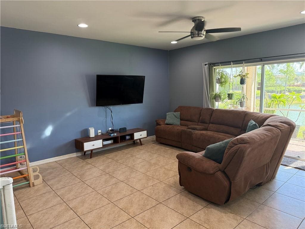 Spacious living area featuring tile flooring, recessed lighting, and a modern ceiling fan