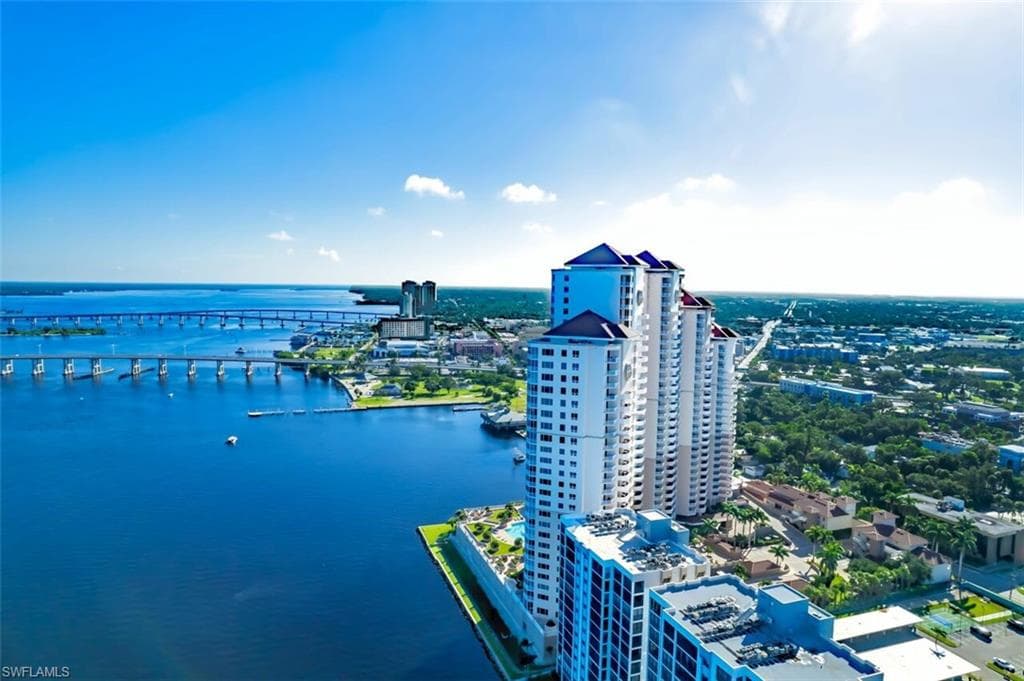 Birds eye view of property with a water view