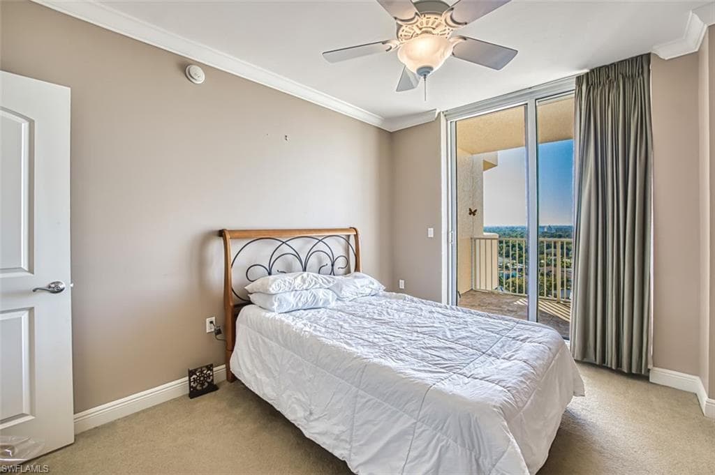Carpeted bedroom featuring ceiling fan, crown molding, and access to outside