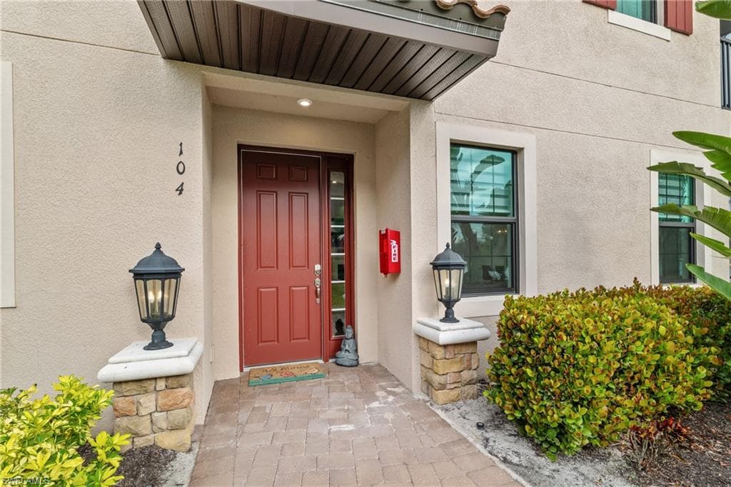 Entrance to property with stucco siding