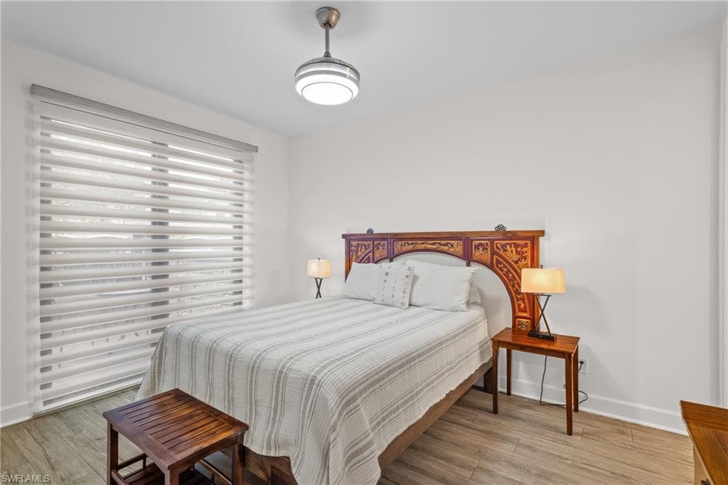 Bedroom featuring light wood finished floors and baseboards