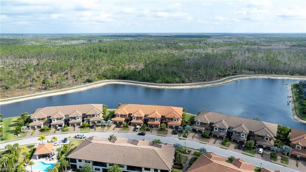 Aerial view of a nearby body of water and a heavily wooded area