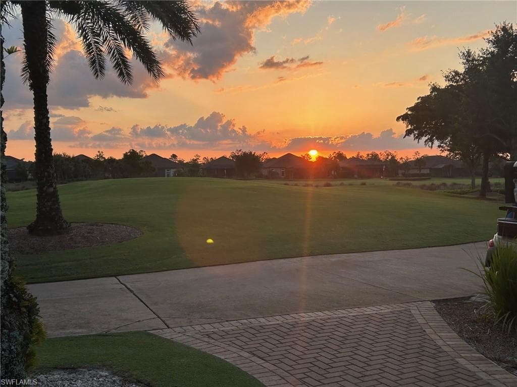 View of community featuring a lawn and view of golf course