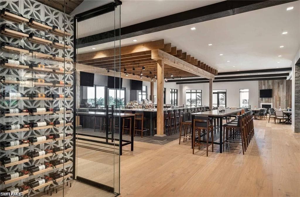 Bar with healthy amount of natural light and beamed ceiling