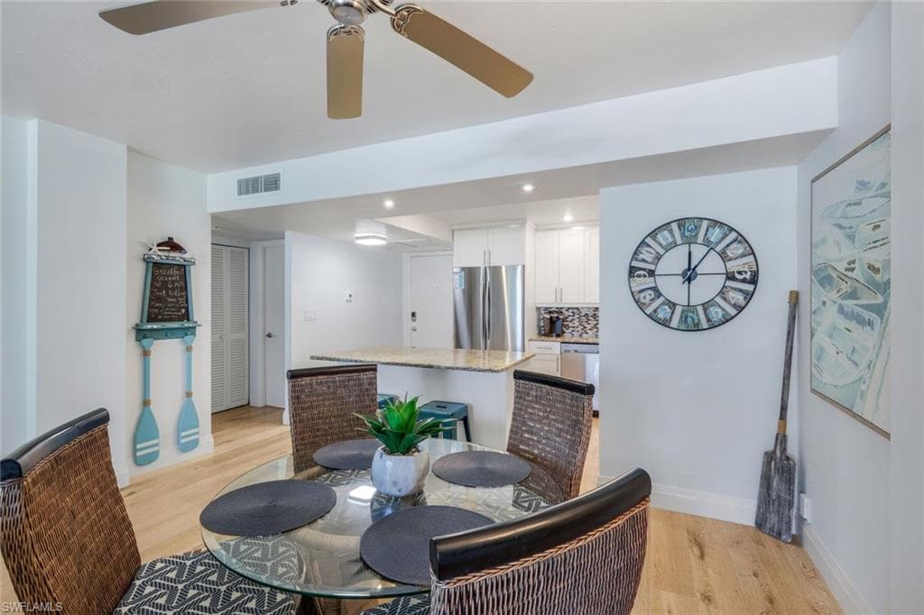 Open-concept dining area featuring a glass-top table