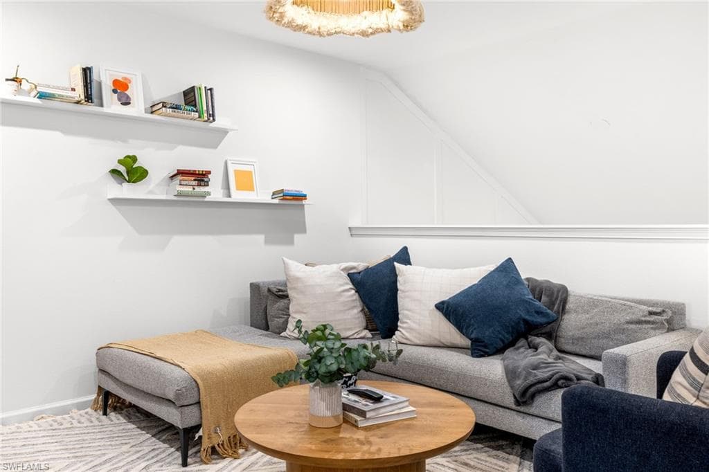 Living area with bright white walls and a contemporary chandelier