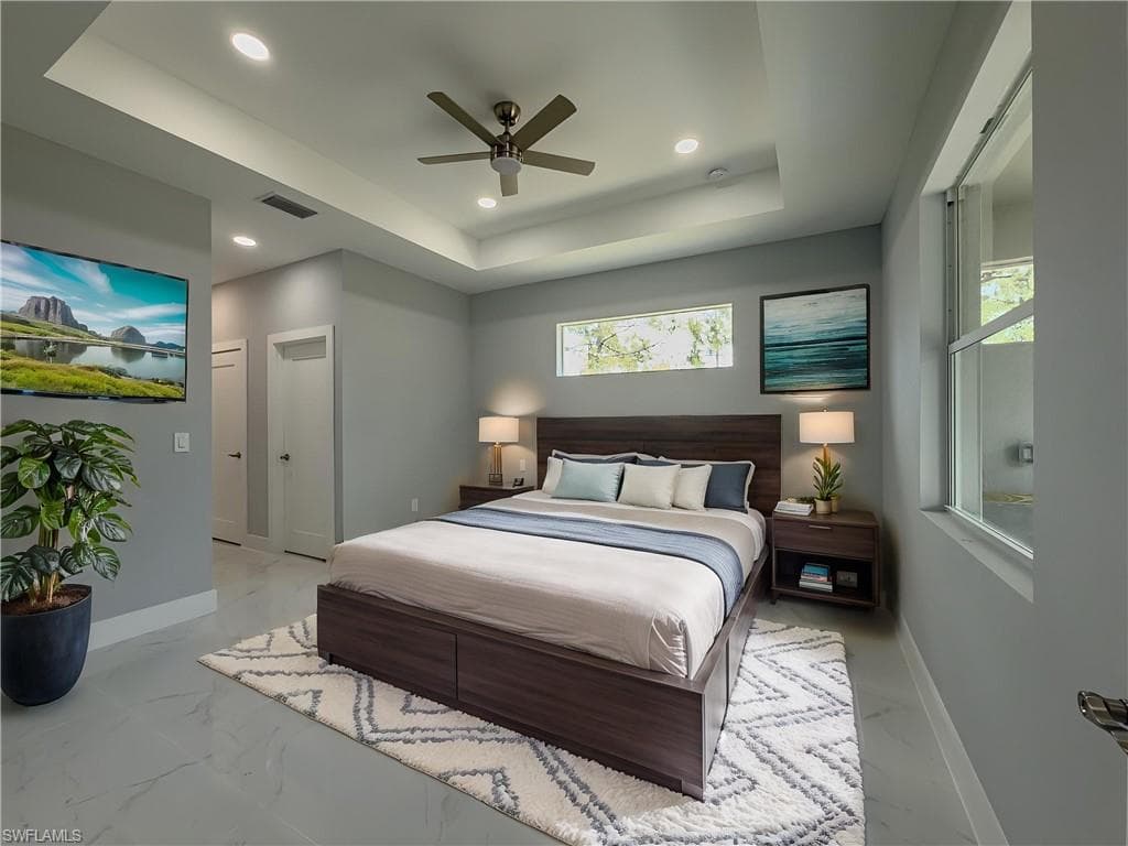 Master Bedrrom with visible vents, recessed lighting, a raised ceiling, and baseboards
