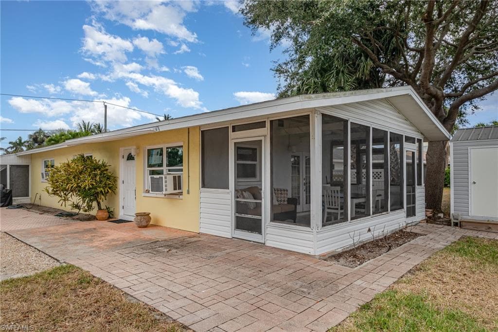 The yellow stucco exterior is highlighted by white entry doors and windows!