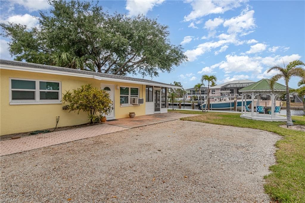 Surrounding the parking area is a gazebo and mature palm trees!