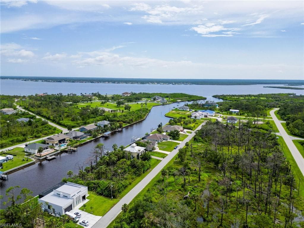 Aerial perspective of suburban area featuring a large body of water
