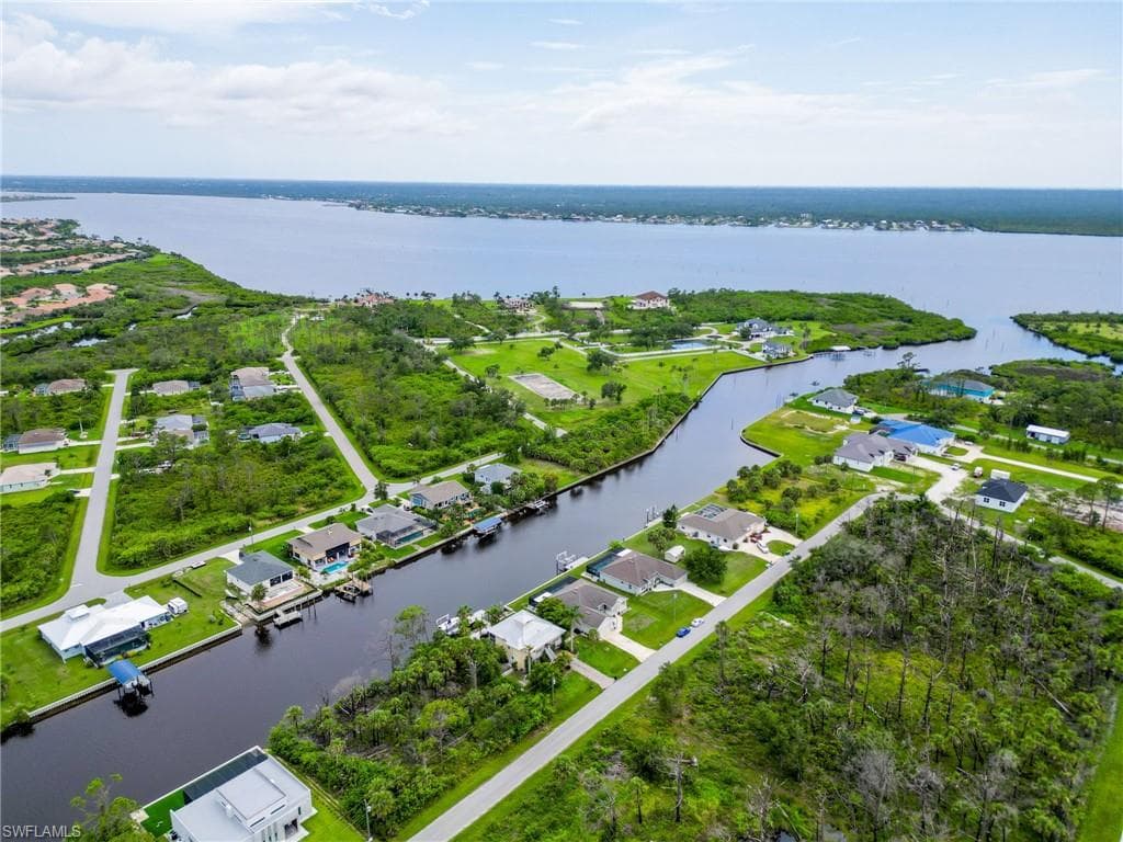 Aerial overview of property's location with a large body of water and nearby suburban area
