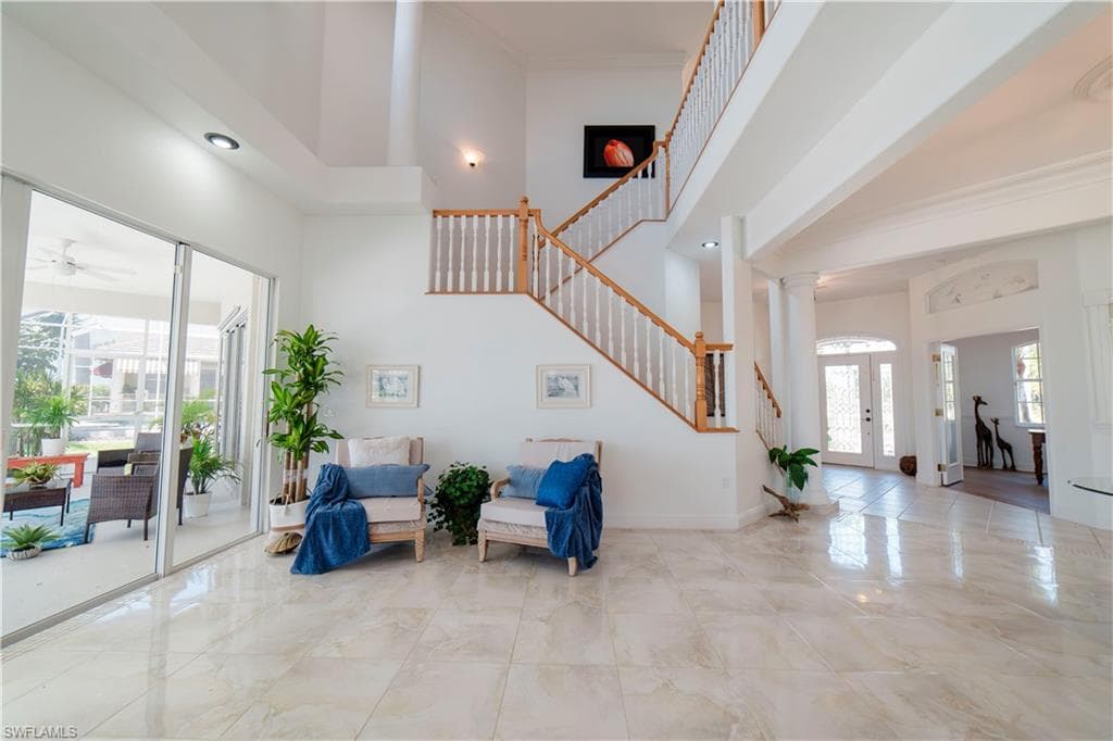 24 Foot Ceiling and Sliders overlooking pool area and bay