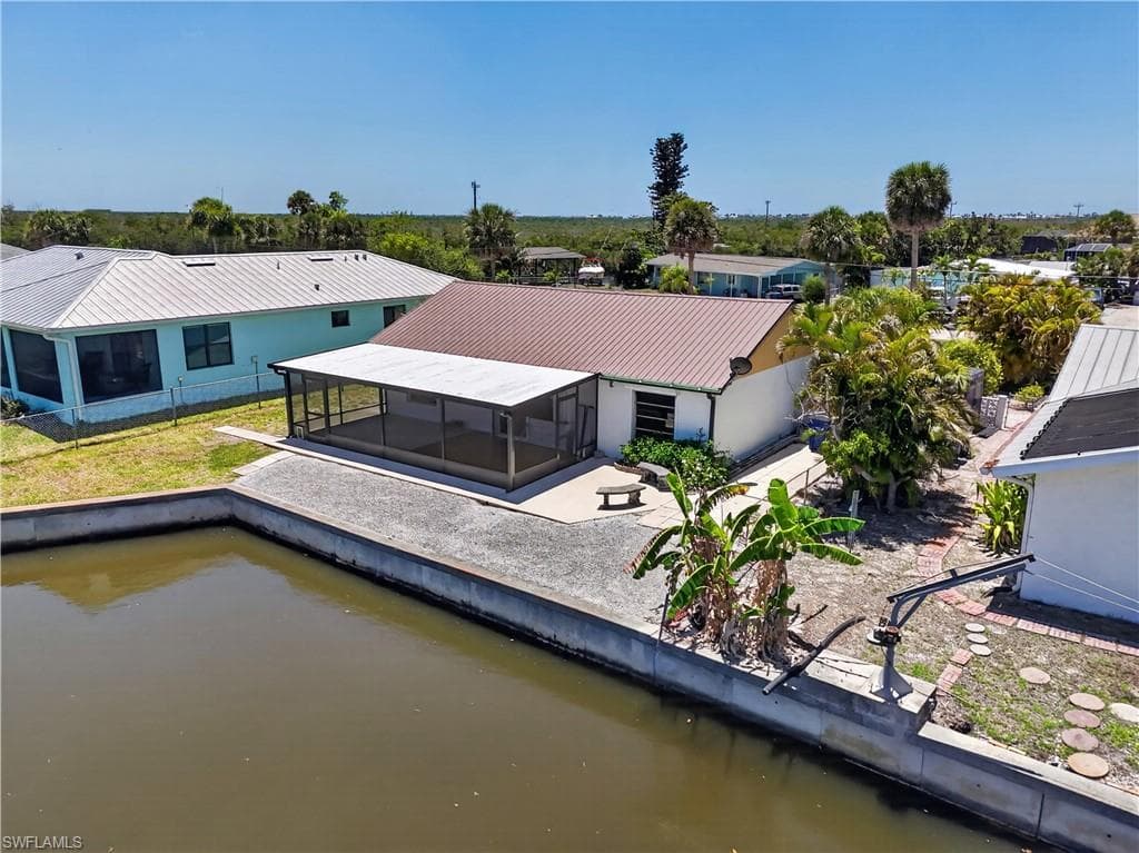 Home at beginning of widened canal with plenty of room to add dock and/or pool.