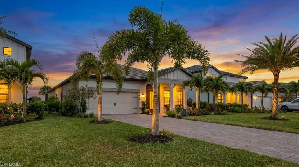 Contemporary single-story residence featuring a gray shingle roof and a light-toned exterior