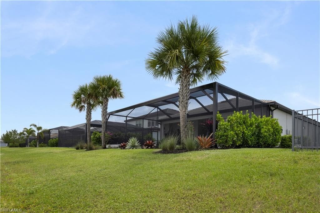 Expansive green lawn featuring mature palm trees and established landscaping
