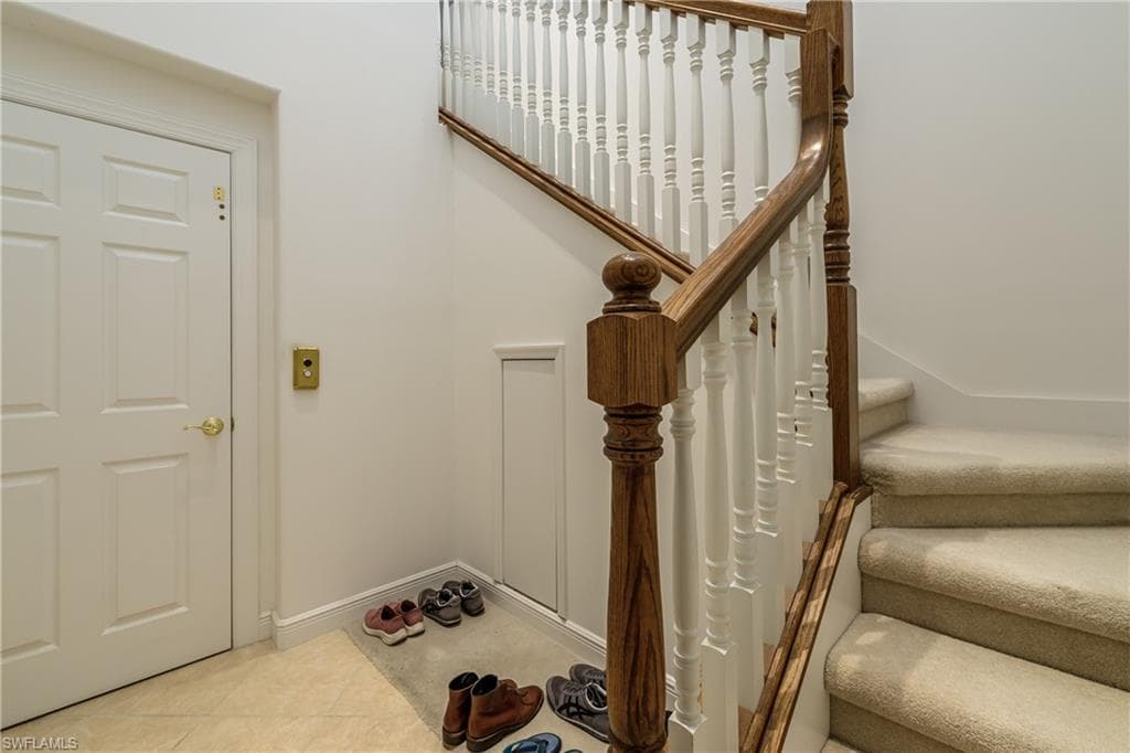 Staircase featuring tile patterned flooring