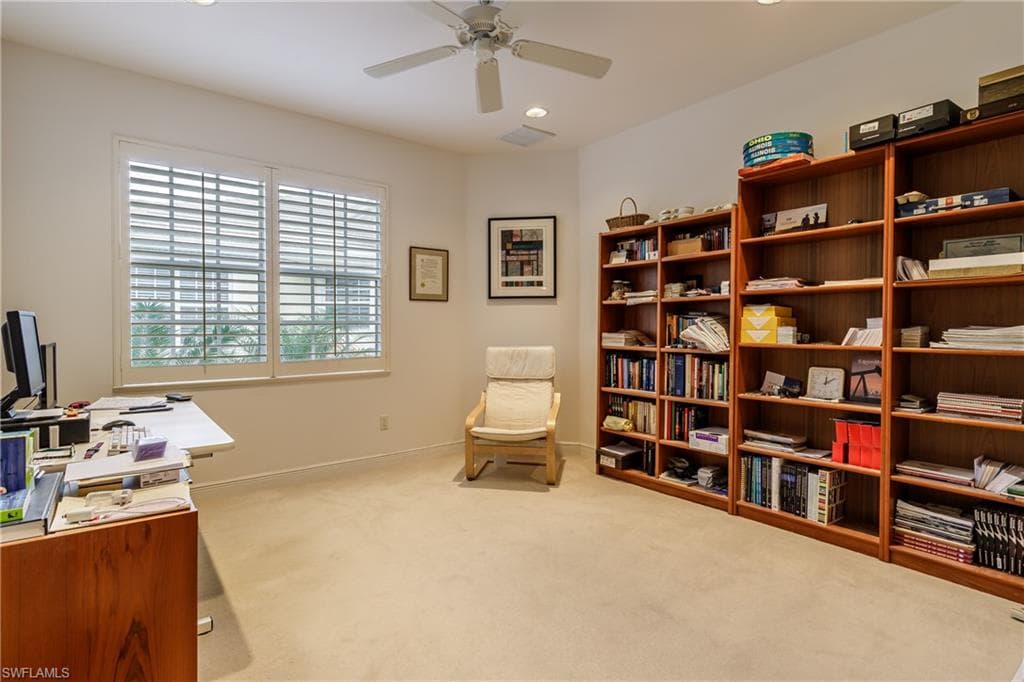Carpeted office featuring baseboards, visible vents, a ceiling fan, and recessed lighting