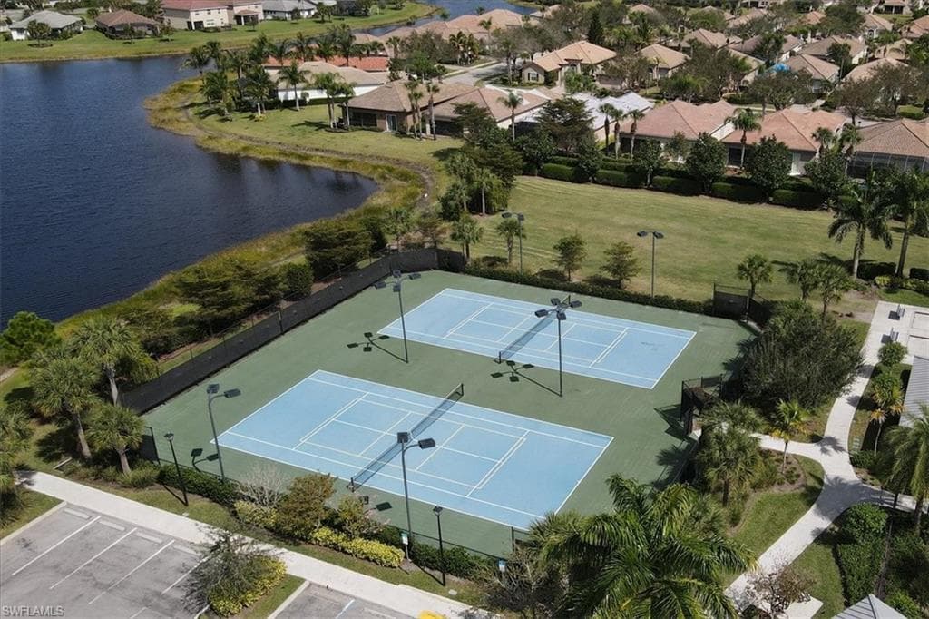 Drone / aerial view with a residential view and a water view