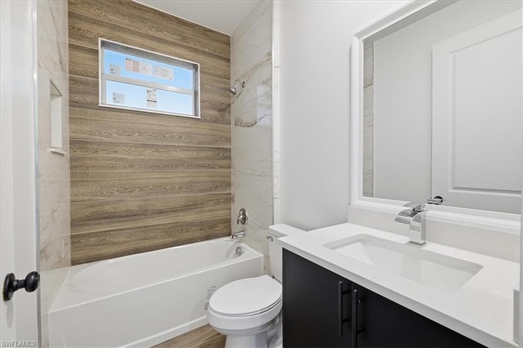 Full bathroom featuring a single white vanity with a rectangular integrated sink, chrome faucet, and dark wood-finish cabinetry