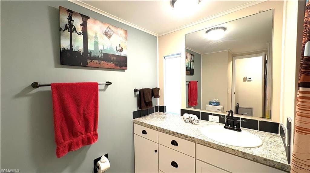 Hall Bathroom has a granite-finish countertop and shower, with integrated sink, patterned countertop, and black tile backsplash