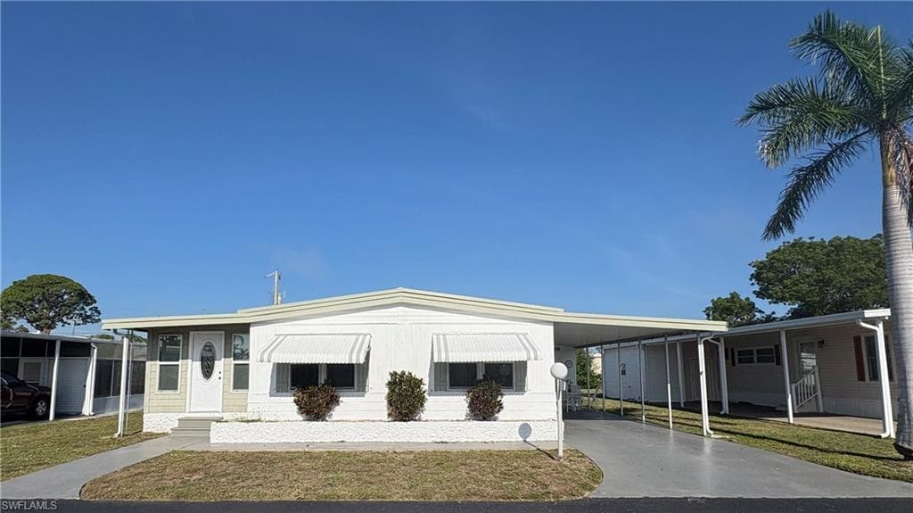 Awnings all around for energy savings and storm protection, along with ample parking under the covered carport.