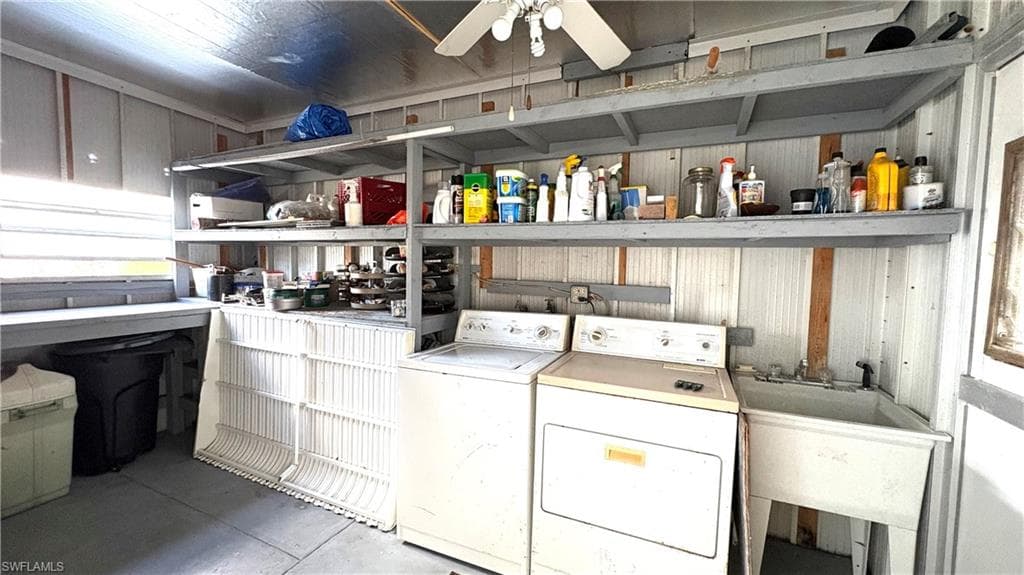 Dedicated laundry area featuring a utility sink and overhead shelving. washer and dryer are included.