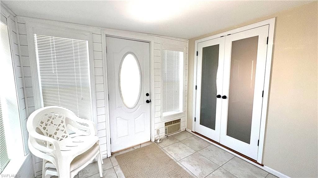 The air-conditioned Florida room has new doors, windows, and integrated blinds.