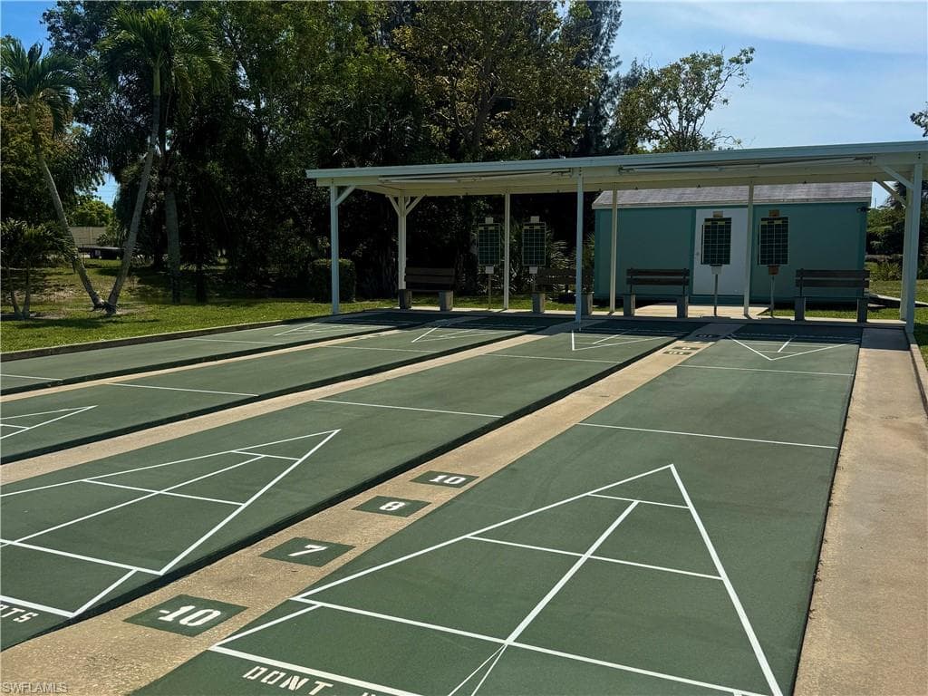 Outdoor shuffleboard courts with green playing surfaces and white markings