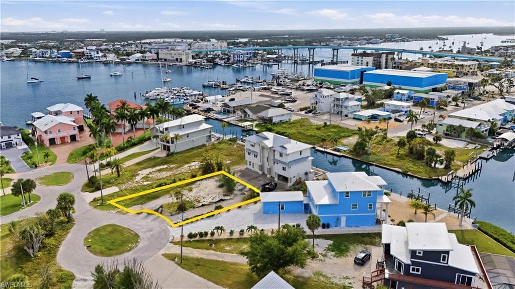 Aerial view of lot surrounded by bay- virtually enhanced