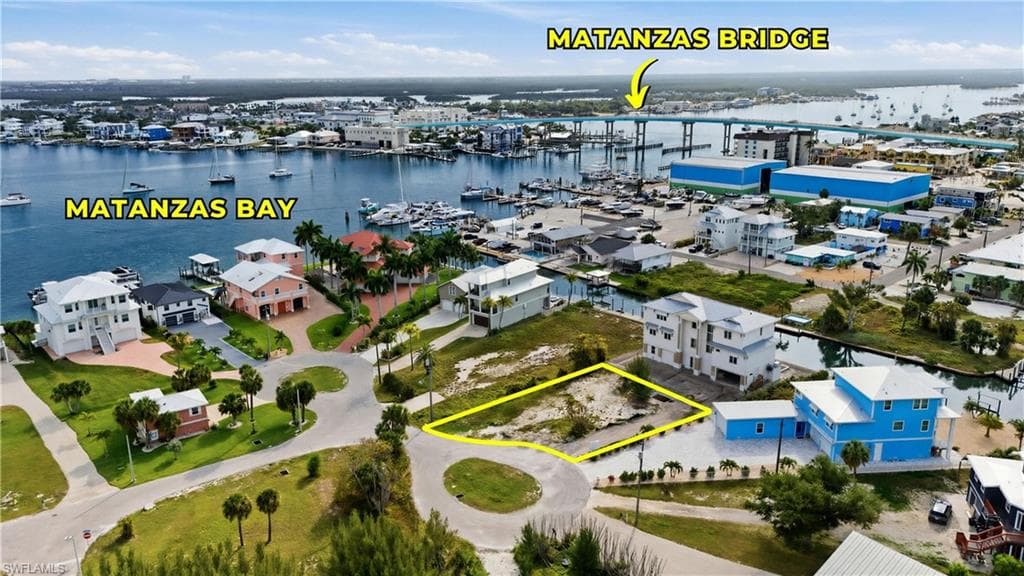 Vacant land parcel situated on a paved street, featuring surrounding residential properties, proximity to a canal, and access to Matanzas Bay via waterways - Virtually Edited Image