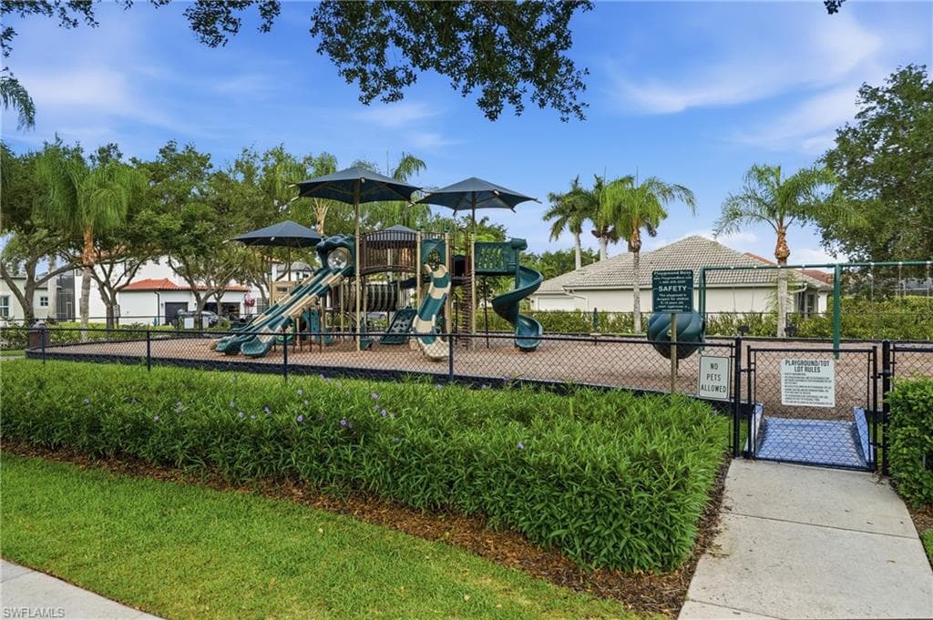 Community playground featuring multiple slides, climbing structures, and protective surfacing