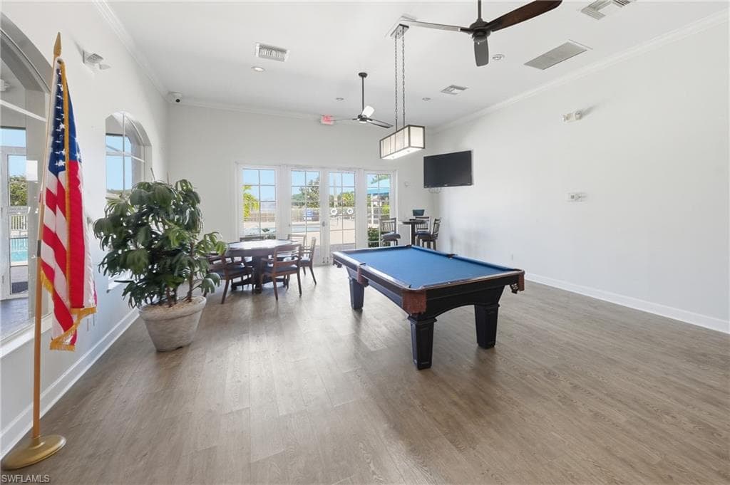 Expansive recreation room featuring wood-finish flooring, high ceilings, and a pool table