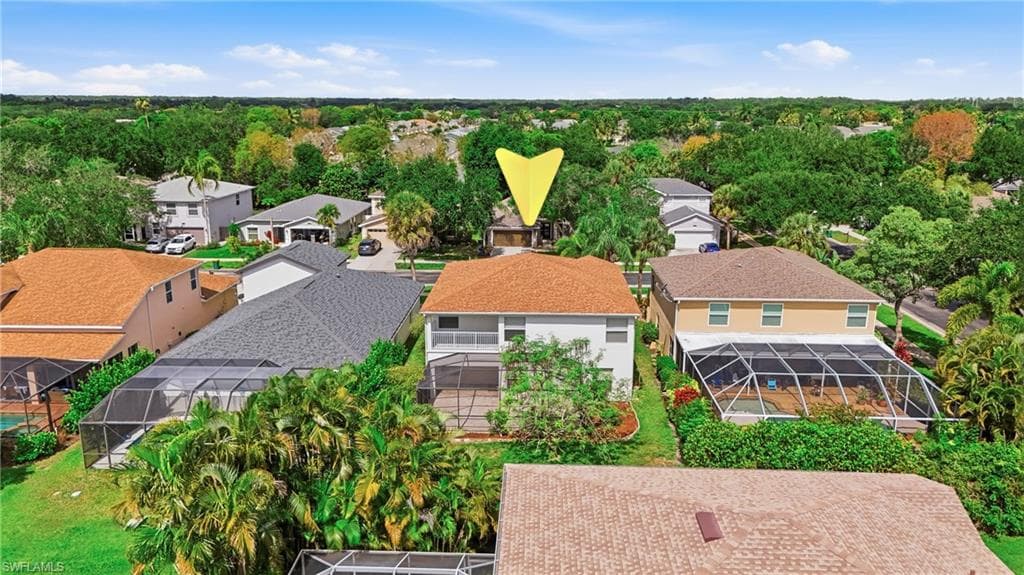 Two-story residence featuring a screened-in pool enclosure and an upper-level balcony