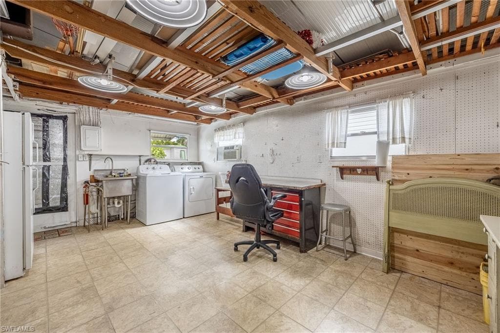This is a large work room w/ newer washer & Dryer, AC, utility sink, beverage refrigerator and exit to back patio.