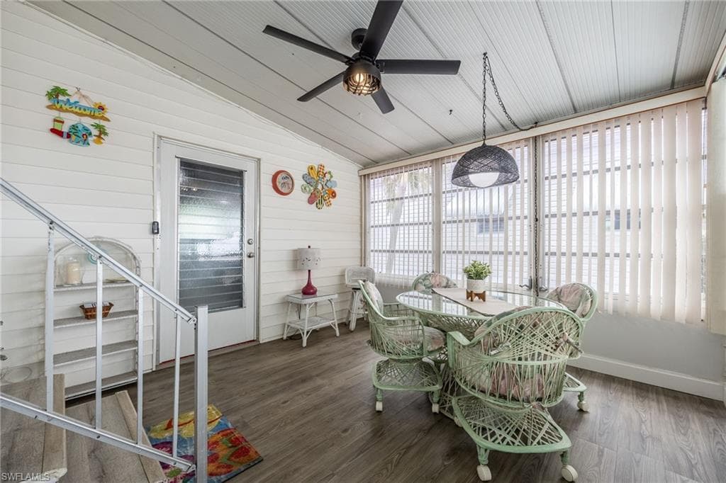 New flooring, new fan, surround glass windows and screens. Great extra space - this is your lanai/Florida Room! Access from home and car port and leads to the huge workroom/laundry space.