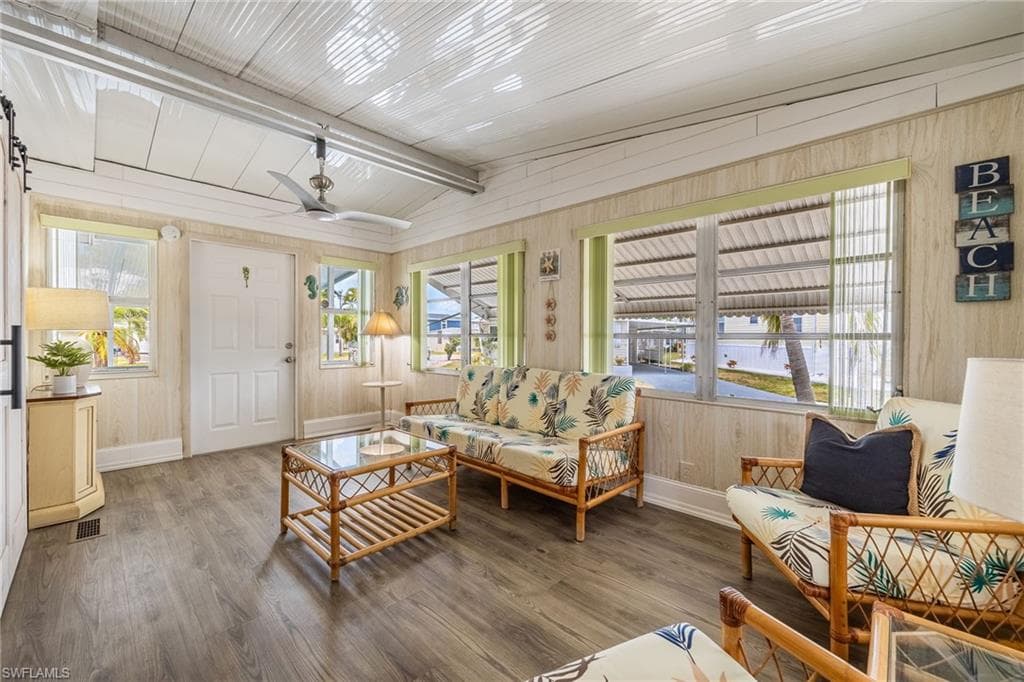 Large den filled with natural light. High ceilings with new fan.